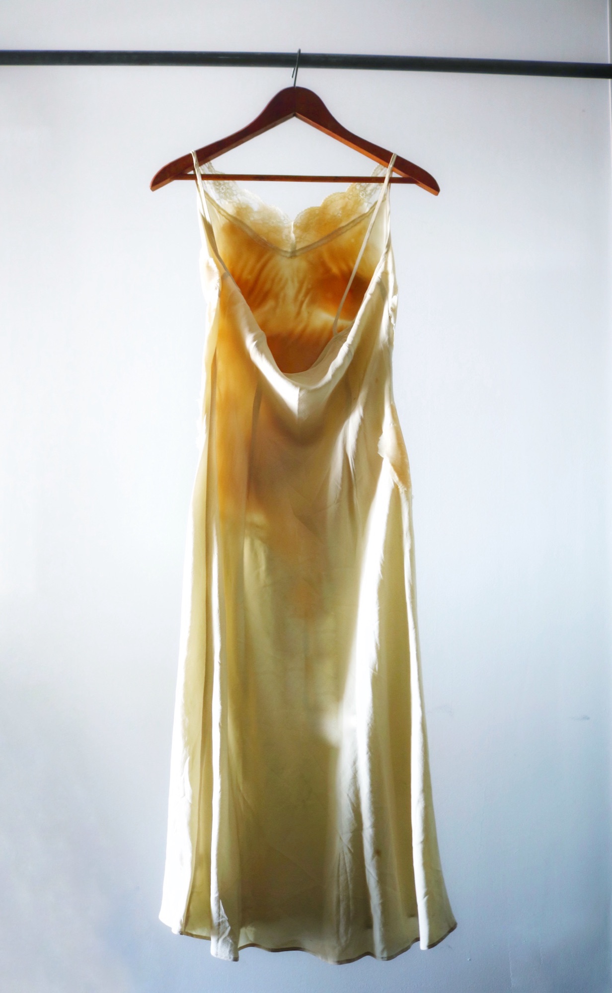 The nightgown hanging against a white background